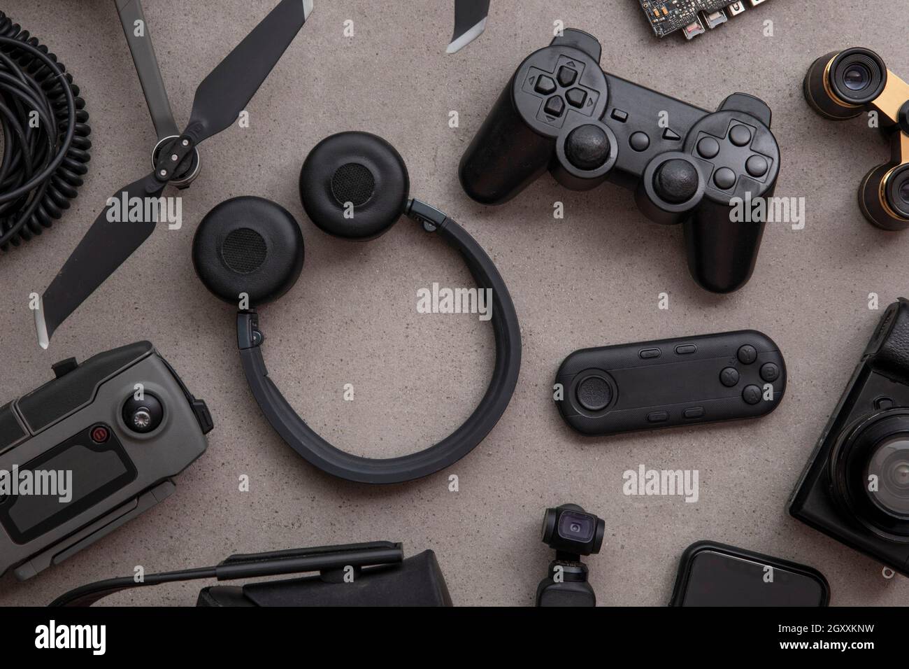 Über dem Kopf plattes Lay von schwarzen Technologie-Geräten und Gadgets auf einem grauen Hintergrund Stockfoto