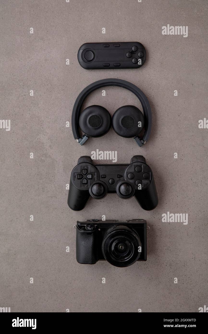 Über dem Kopf plattes Lay von schwarzen Technologie-Geräten und Gadgets auf einem grauen Hintergrund Stockfoto