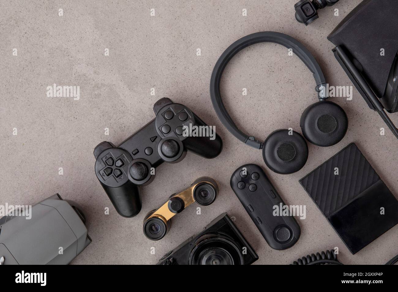 Über dem Kopf plattes Lay von schwarzen Technologie-Geräten und Gadgets auf einem grauen Hintergrund Stockfoto