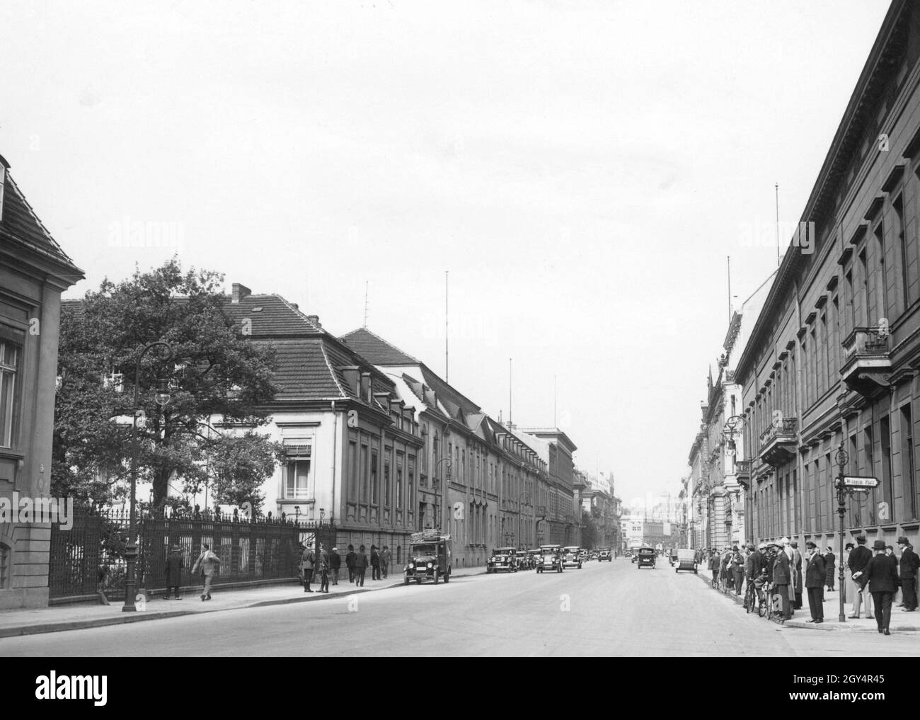 Das Foto zeigt die Kanzlerei des Alten Reiches und das Auswärtige Amt (links) in der Wilhelmstraße und das Ordenspalais am Wilhelmplatz (rechts) in Berlin-Mitte im Sommer 1932. Der Blick geht in Richtung unter den Linden mit dem Luxus Hotel Adlon an der linken Ecke. [Automatisierte Übersetzung] Stockfoto