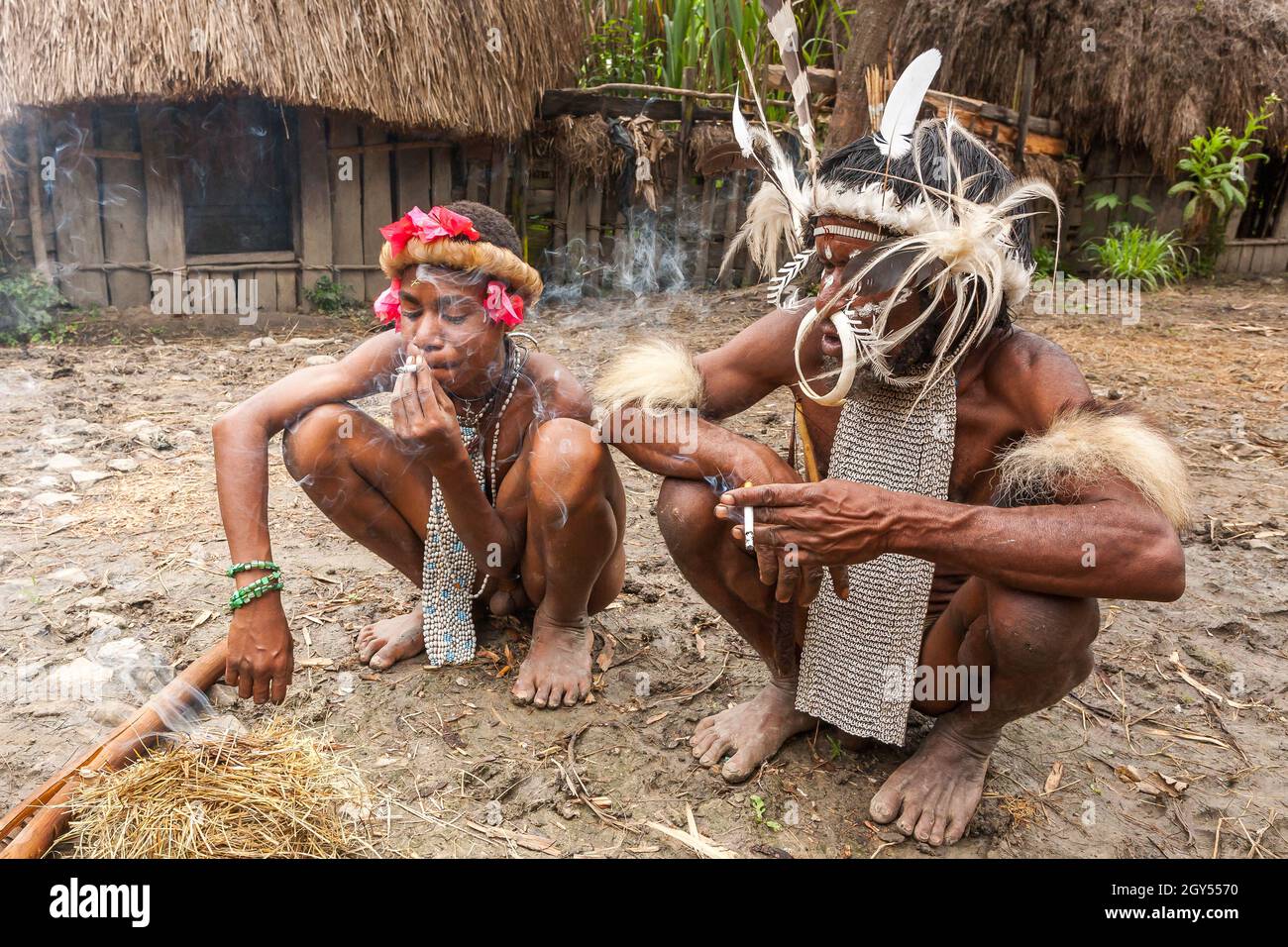 Wamena, Indonesien - 9. Januar 2010: Zwei Männer des Dani-Stammes rauchten die Zigaretten im Dorf Wamena. Stockfoto