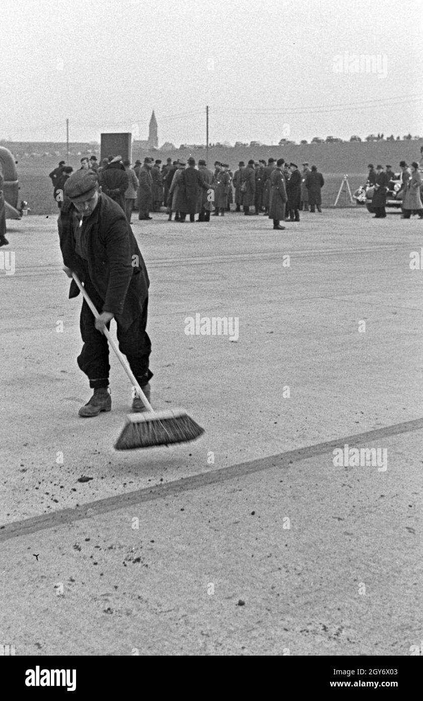 Straße wird gefegt für den Weltrekordversuch mit dem Mercedes Benz W 125, Deutschland 1930er Jahre sterben. Straße ist für den Weltrekord Versuch mit der Mercedes Benz W 125, Deutschland 1930 fegte. Stockfoto