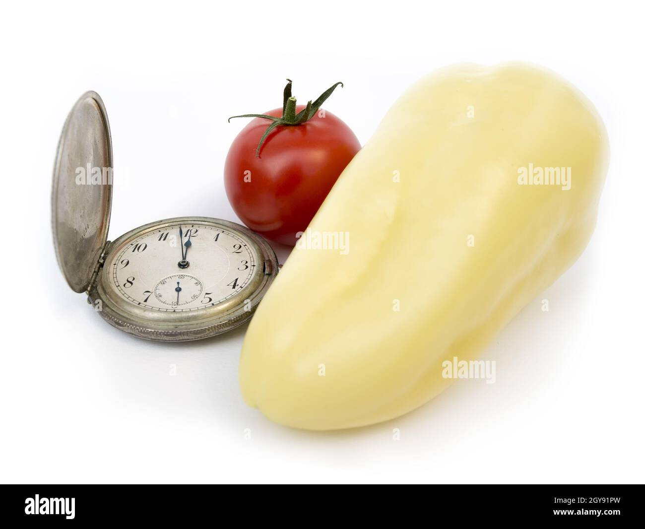 Zeit des Konsums, alte Uhr, Tomaten, Pfeffer, die Lösung von Hungersnot Probleme, Essen teilen Stockfoto