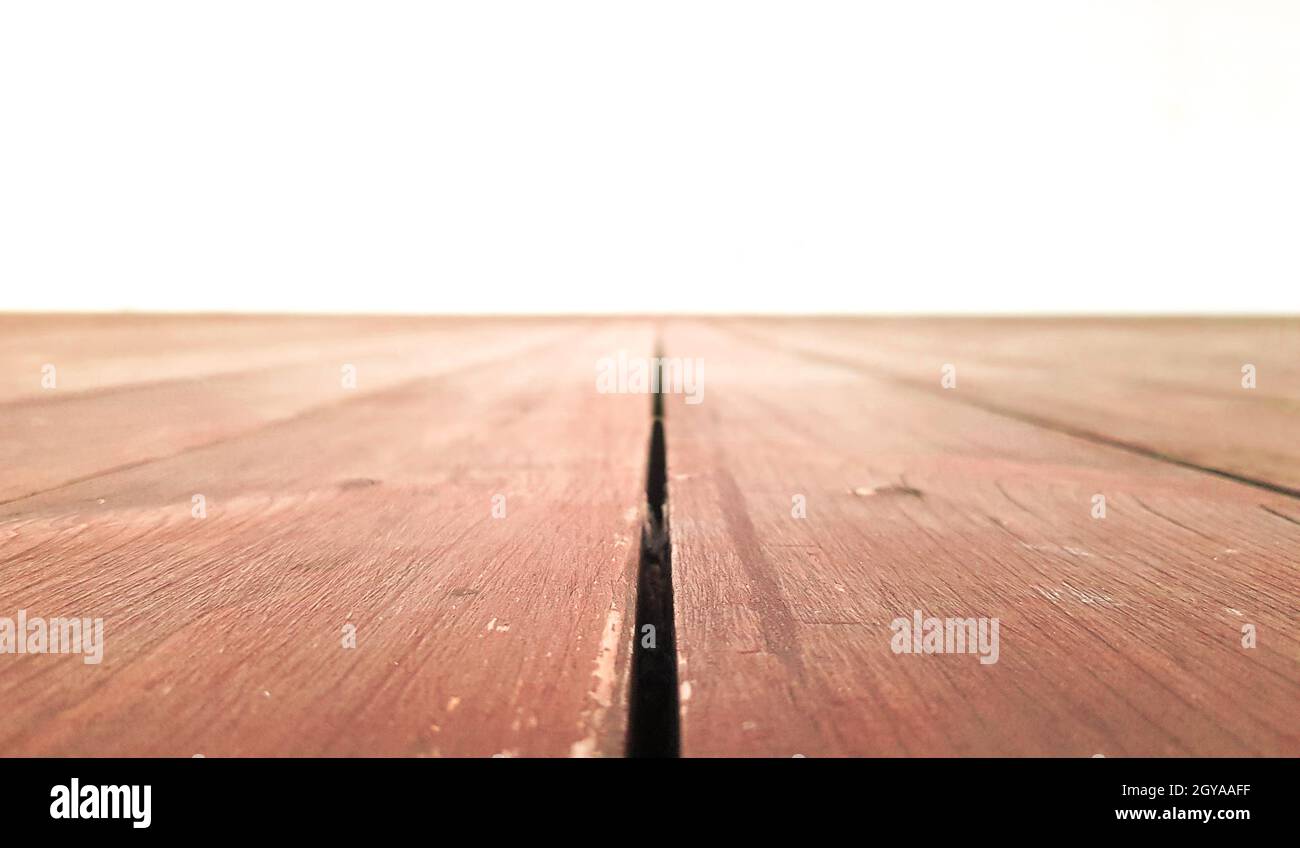 Holzbrett leerer Tisch vor weißem Hintergrund. Brown Wood Perspective - kann verwendet werden, um Ihre Produkte zu präsentieren oder zu montieren. Nimm dich den Dämonen entgegen Stockfoto
