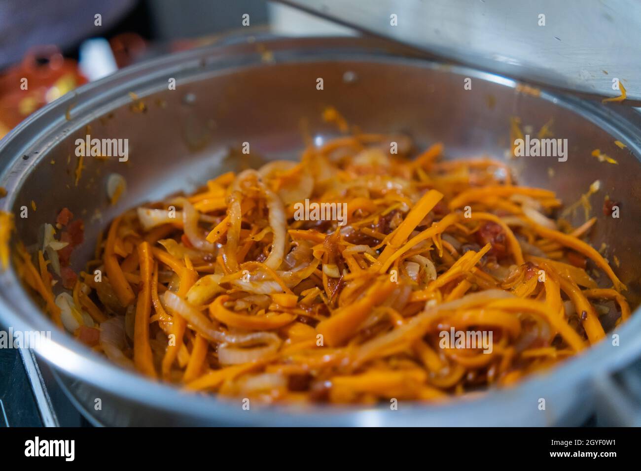 Leckere Yam-, Karotten-, Tomaten- und Zwiebelscheiben in einem Kochtopf Stockfoto