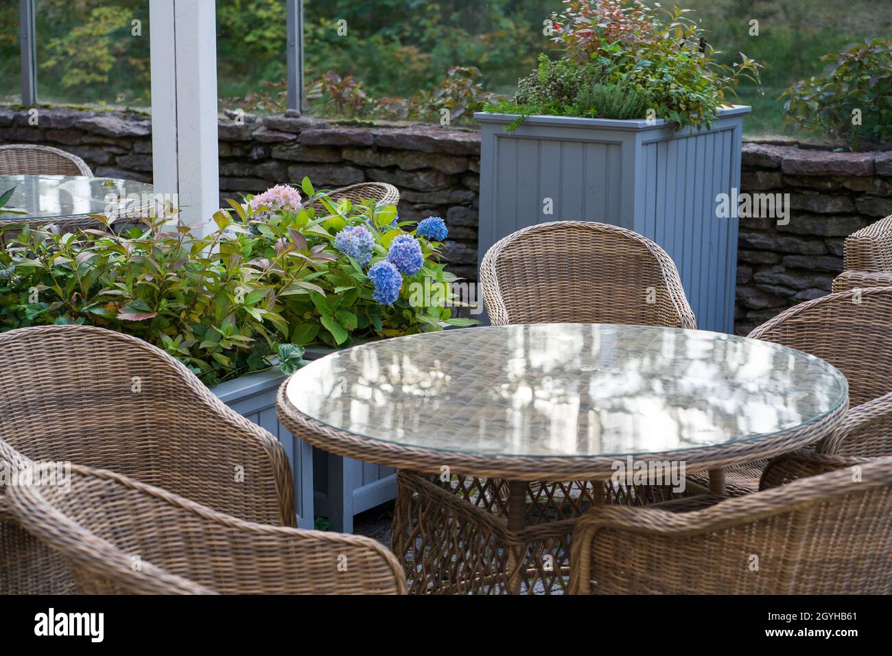 Gemütliche Terrasse im Restaurant, Café oder Hotel im Stadtgarten, Park oder Wald ohne Menschen Stockfoto