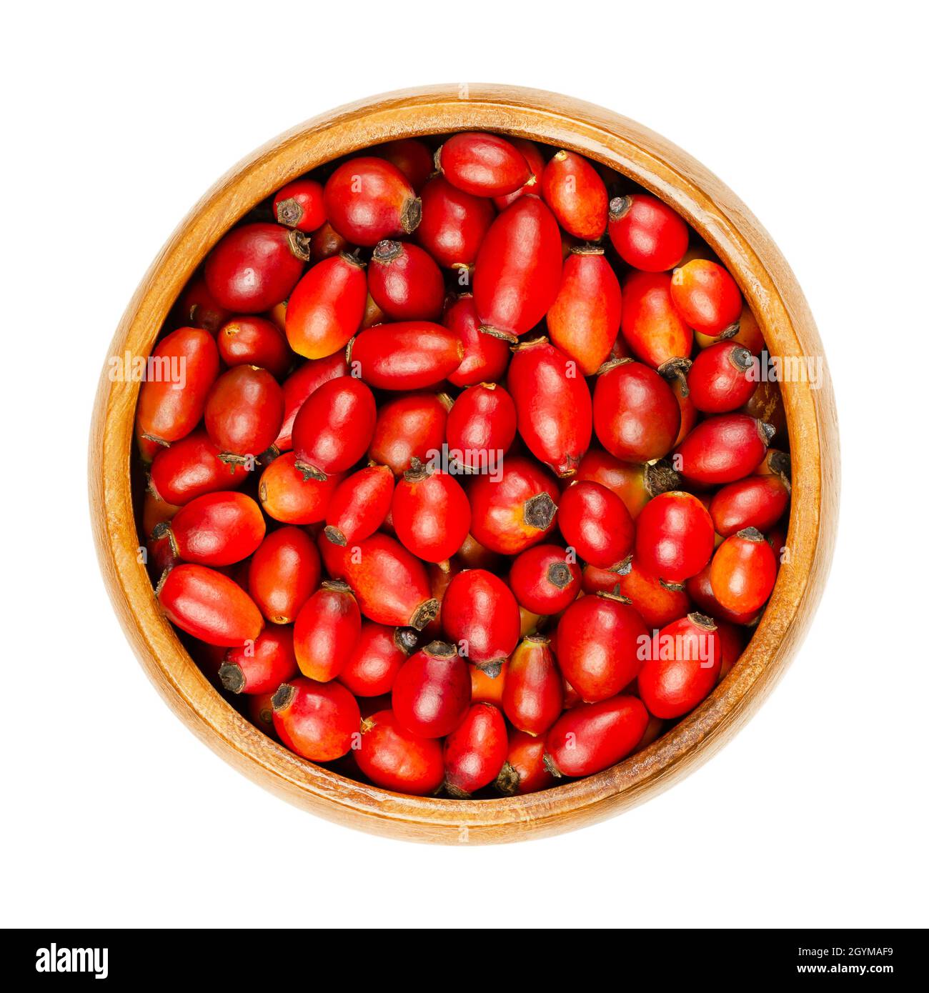 Frische, wilde Hagebutten in einer Holzschale. Auch Rosenhaw oder Rosenhep. Reife und intensive rote Früchte, die für Kräutertees, Marmelade und roh gegessen werden. Stockfoto