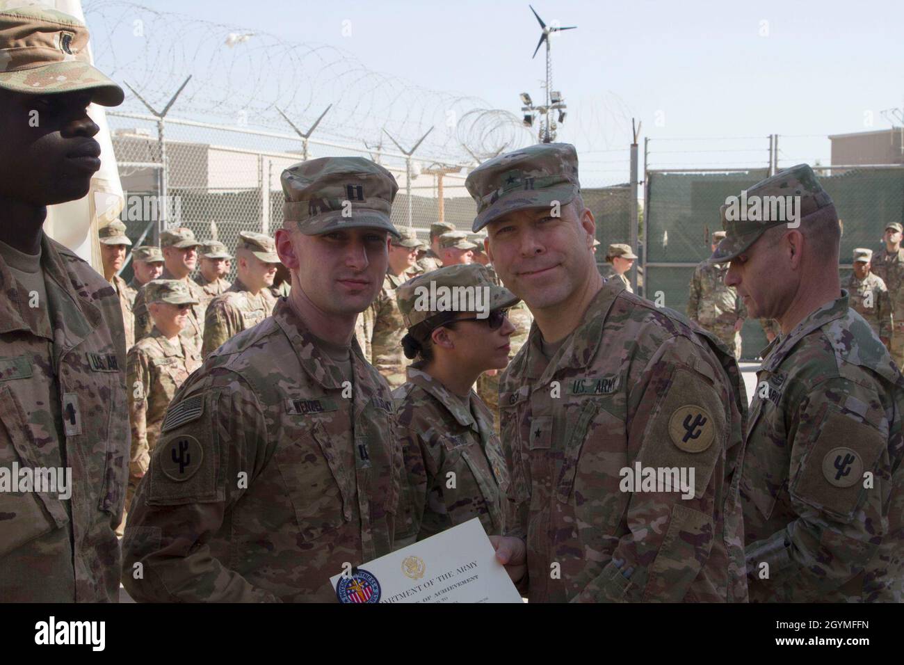 Brig. General Howard Geck, kommandierender General, posiert mit Capt. Zachary Wenzel, 103. Expeditionary Sustainment Command, nachdem er ihm ein Leistungszertifikat und das Army Physical Fitness Abzeichen im Camp Arifjan, Kuwait, am 2. Februar 2020 überreichen hatte. Soldaten müssen bei allen drei Veranstaltungen des Army Physical Fitness Tests mindestens 90 Punkte sammeln, um das Abzeichen zu erhalten. (USA Army Reserve Foto von SPC. Dakota Vanidestine) Stockfoto