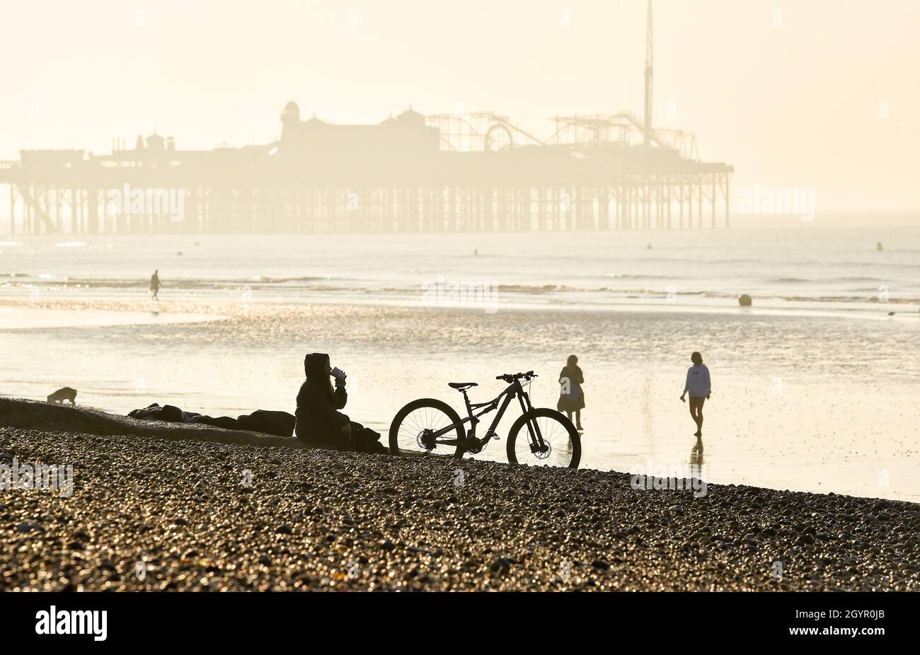 Brighton UK 9. Oktober 2021 - Es ist Zeit, sich an einem schönen sonnigen Morgen am Strand von Brighton zu entspannen, da heute für Teile Großbritanniens warmes, sonniges Wetter prognostiziert wird : Credit Simon Dack / Alamy Live News Stockfoto