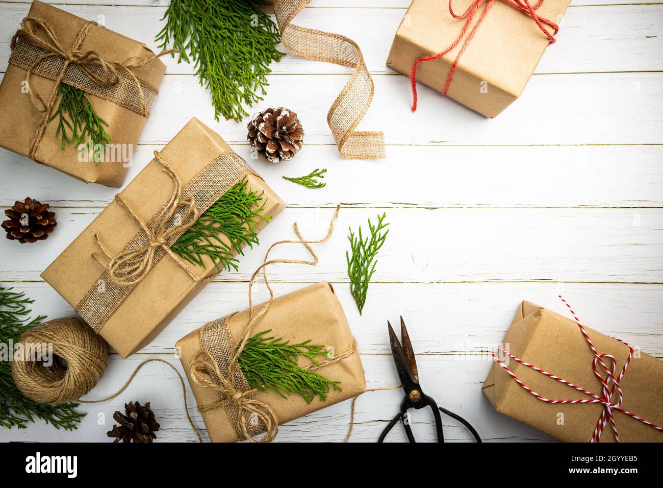 Weihnachtsgeschenk oder Geschenkbox in Kraftpapier mit Dekoration auf  rustikalem Holzhintergrund verpackt, Draufsicht Stockfotografie - Alamy