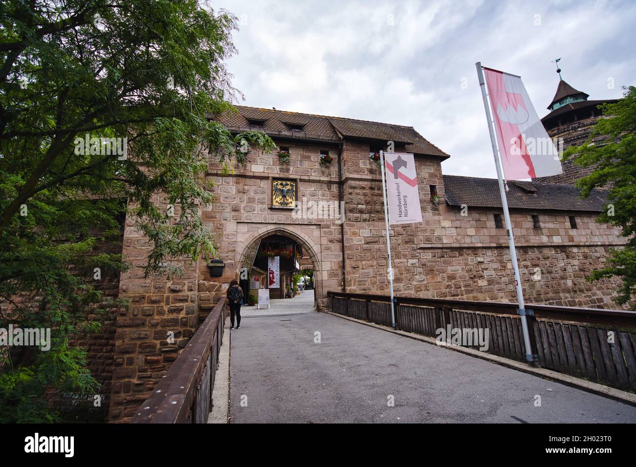 MÜNCHEN, DEUTSCHLAND - 21. Aug 2021: Ein historisches Tor, Eingang zur Stadt Nürnberg. Alte Mauer rund um das Stadtzentrum und ein beliebter Tourist ein Stockfoto