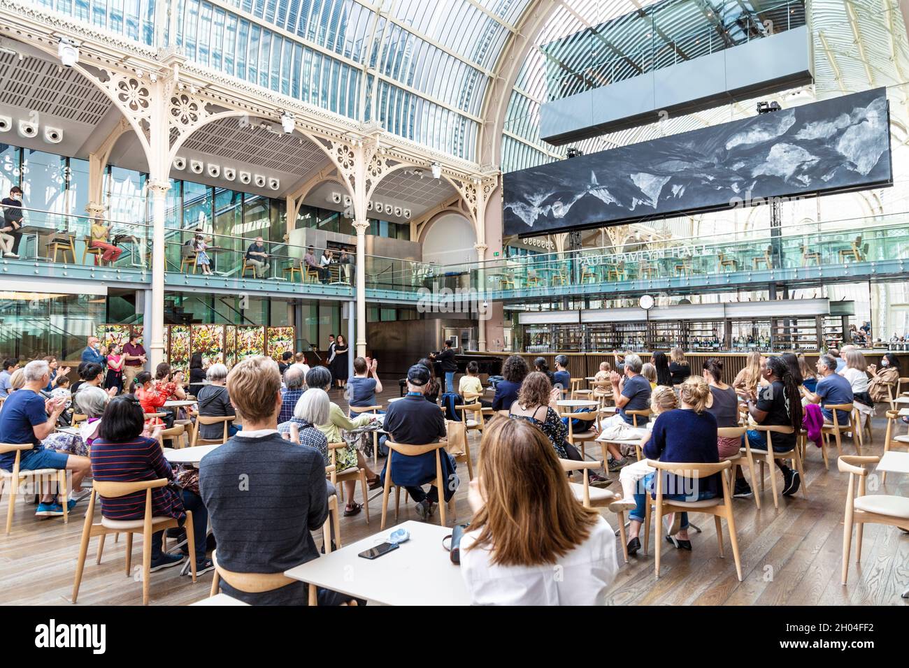 Menschen, die eine Opernaufführung in der Paul Hamlyn Hall (Floral Hall) im Royal Opera House, Covent Garden, London, Großbritannien, sehen Stockfoto