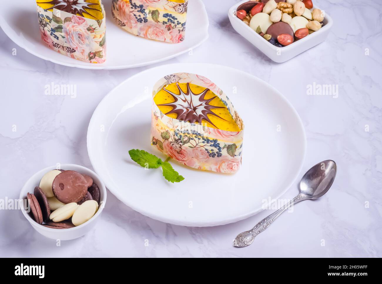 Nusskuchen mit Creme und Glasur auf einem weißen Teller auf Marmorboden Stockfoto