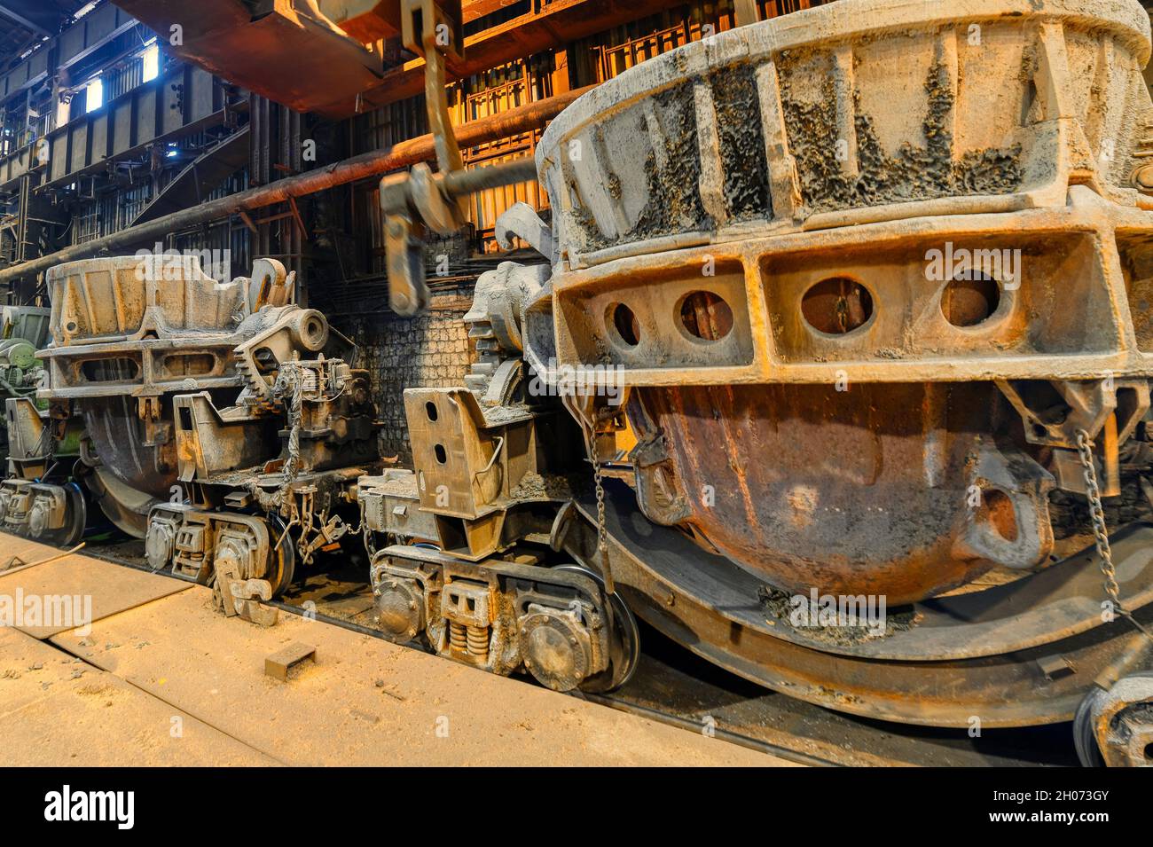 Große metallurgische Schlackenpfannen auf Eisenbahnwagen Stockfoto