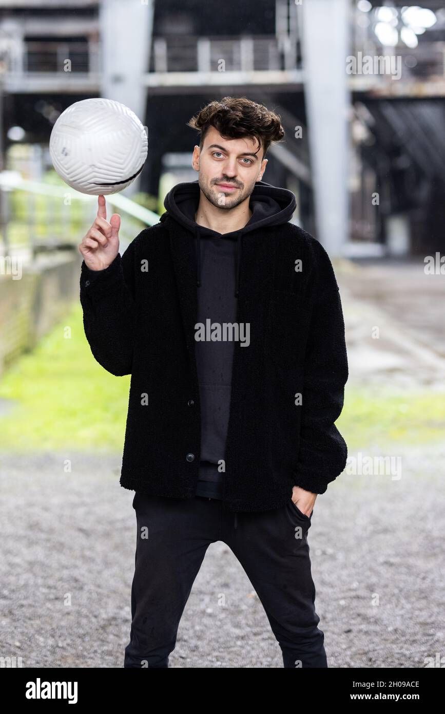 Duisburg, Deutschland. Oktober 2021. Marcel Gurk, zweimaliger deutscher Freestyle-Champion, steht vor einer alten industriellen Kulisse. Spektakuläre Fußballtricks auf TikTok, Familienalltag auf YouTube oder Geschichten aus dem Nebenjob auf Instagram – immer mehr Fußballer und auch Schiedsrichter aus den Klassen unterhalb der 3. Liga präsentieren sich und ihr Leben in den sozialen Netzwerken. Quelle: Marcel Kusch/dpa/Alamy Live News Stockfoto