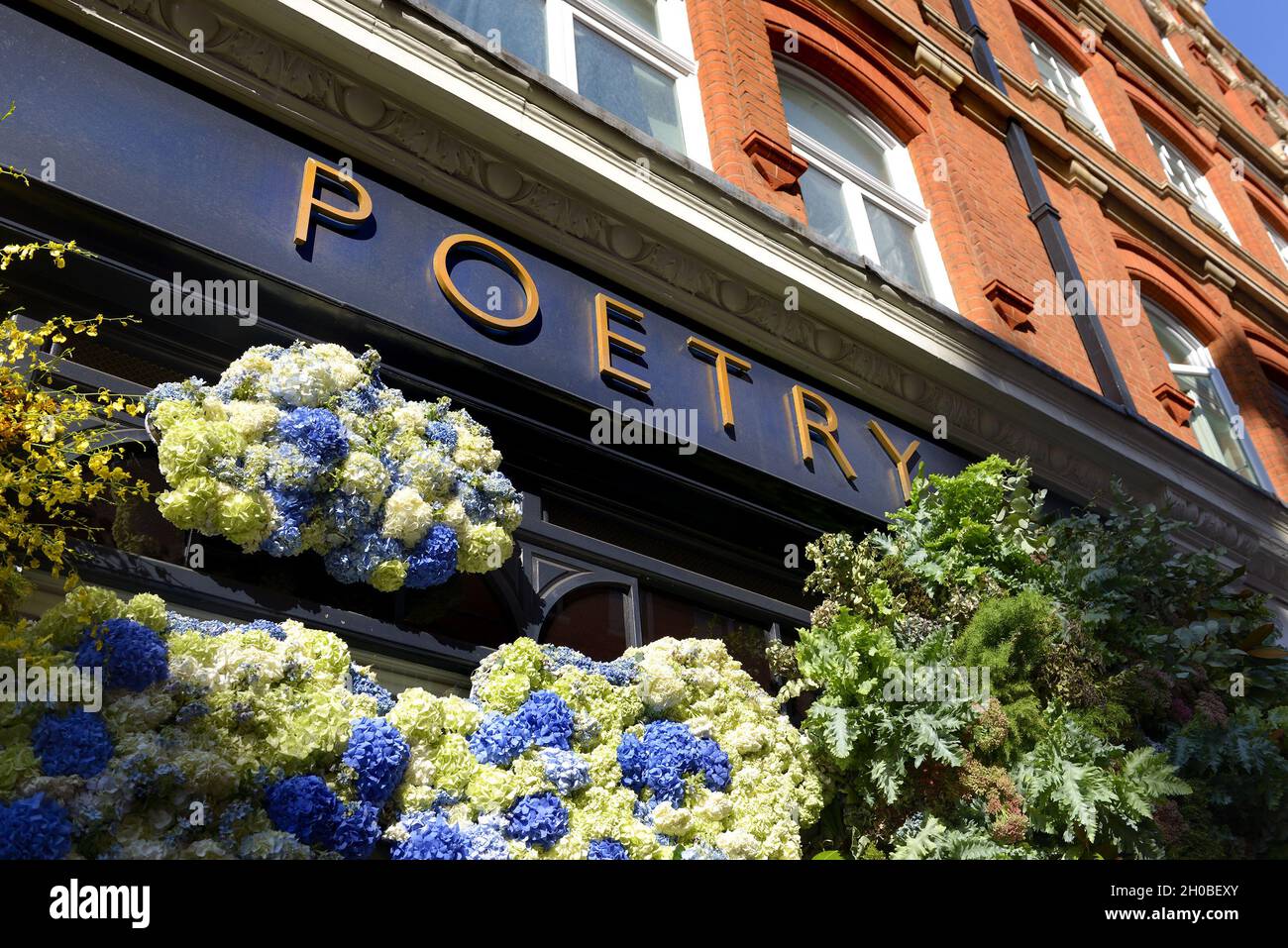 „Poetry“-Damenmodegeschäft an der King's Road, während der jährlichen Blumenkunstshow Chelsea in Bloom und der Blumendusche in den Geschäften und Straßen von Chelse Stockfoto