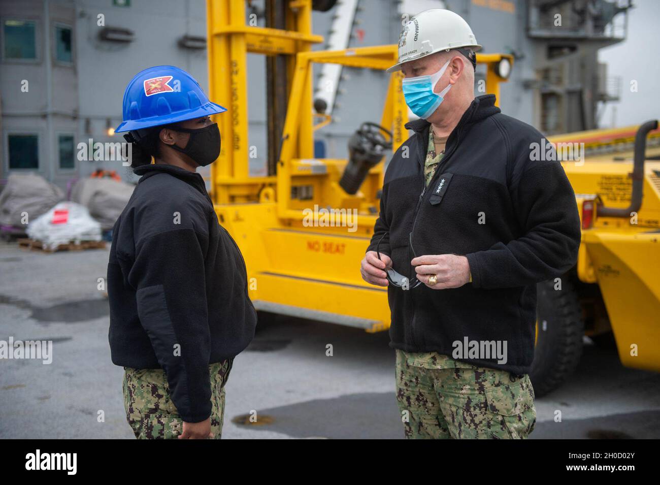 210127-N-XR893-0538 PORTSMOUTH, VA (Jan 27, 2021) Feuerwehrmann Doriyanna ward aus Jacksonville, Florida, links, spricht mit ADM. Christopher Grady, Kommandant, U.S. Fleet Forces Command, auf dem Flugdeck des Flugzeugträgers USS Harry S. Truman der Nimitz-Klasse (CVN 75). Truman befindet sich derzeit in der Norfolk Naval Shipyard wegen seiner Extended Carrier Incremental Availability (ECIA). Die Partnerschaft der Marine mit den Industriearbeitern ist für die nationale Sicherheit und die nationalen Anstrengungen, die erforderlich sind, um auf der globalen Bühne zu konkurrieren und zu gewinnen, von entscheidender Bedeutung. Stockfoto