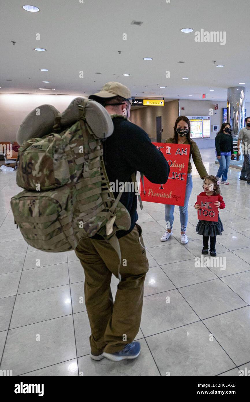 Mitglieder der 58. Expeditionary Military Intelligence Brigade der Maryland Army National Guard mit Sitz in Towson, Maryland, und des 629. Military Intelligence Bataillons mit Sitz in Laurel, Maryland, treffen sich am 9. Februar 2021 mit ihren Familien auf dem internationalen Flughafen Thurgood Marshall in Baltimore/Washington. Die Einheiten stellten während ihres Einsatzes in Afghanistan Geheimdienste zur Verfügung. Sie waren die erste militärische Geheimdienstbrigade der Nationalgarde, die zur Unterstützung von Kampfhandlungen eingesetzt wurde. Stockfoto