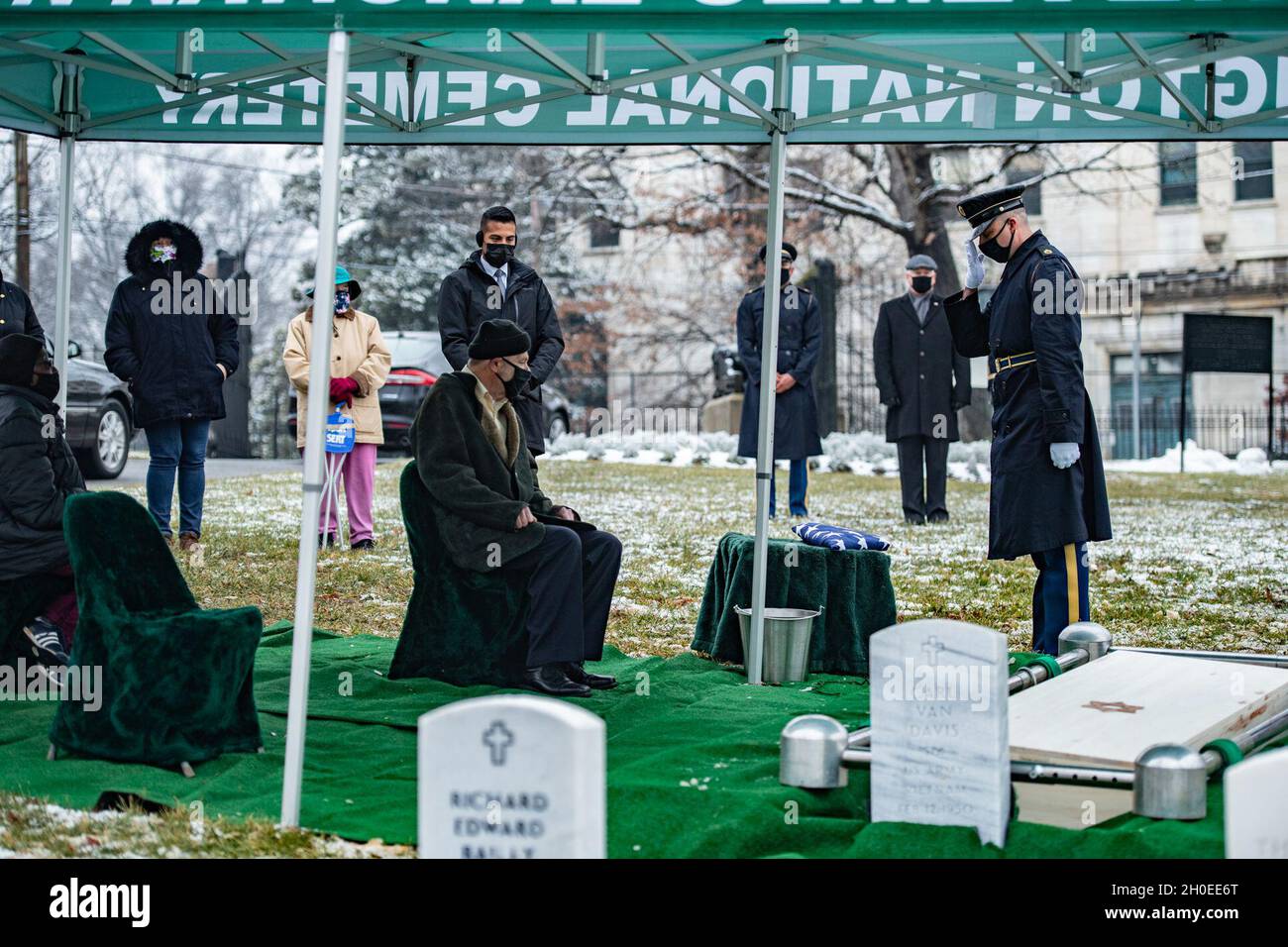 Daniel Clark (links sitzend) erhält die US-Flagge bei der modifizierten Beerdigung von U.S. Army Air Forces Pvt. Miriam Rivkin, Clarks Schwiegermutter, in Sektion Q des US Soldiers’ and Airmen’s Home National Cemetery, Washington, D.C., 11. Februar 2021. Rivkin trat 1943 dem Frauenhilfsluftkorps bei und diente während des Zweiten Weltkriegs zwei Jahre lang. Sie war eine der einzigen Soldatinnen im China-Burma-Indien-Theater des Krieges und diente als Fotografin. Nachdem sie den Dienst verlassen hatte, hatte Rivkin eine 50-jährige Karriere in der New Yorker Modebranche. Als sie starb, war Rivkin livi Stockfoto