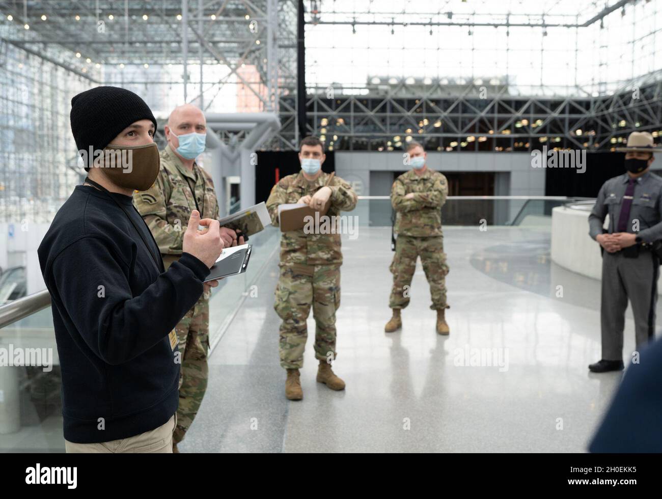 Offiziere der US-Armee, hochrangige, nicht beauftragte Offiziere, die dem 53. Truppenkommando und dem Hauptquartier der Vereinten Kräfte zugewiesen wurden, und Staatspartner, die der New Yorker Staatspolizei und der Exekutivkammer der Regierung des Bundesstaates New York zugewiesen wurden, Überprüfung der Reaktionsverfahren zur Unterstützung der staatlichen Bemühungen um die Bereitstellung von Massen-COVID-19-Impfungen, die vom Gesundheitsministerium des US-Bundesstaates New York im Javits Convention Center in Manhattan, New York, am 14. Februar 2021 durchgeführt wurden. Die Nationalgarde hat Hunderte von Wachmännern und Frauen, die zur Unterstützung des Personals an der Impfstelle eingesetzt werden. Der New York State Depar Stockfoto