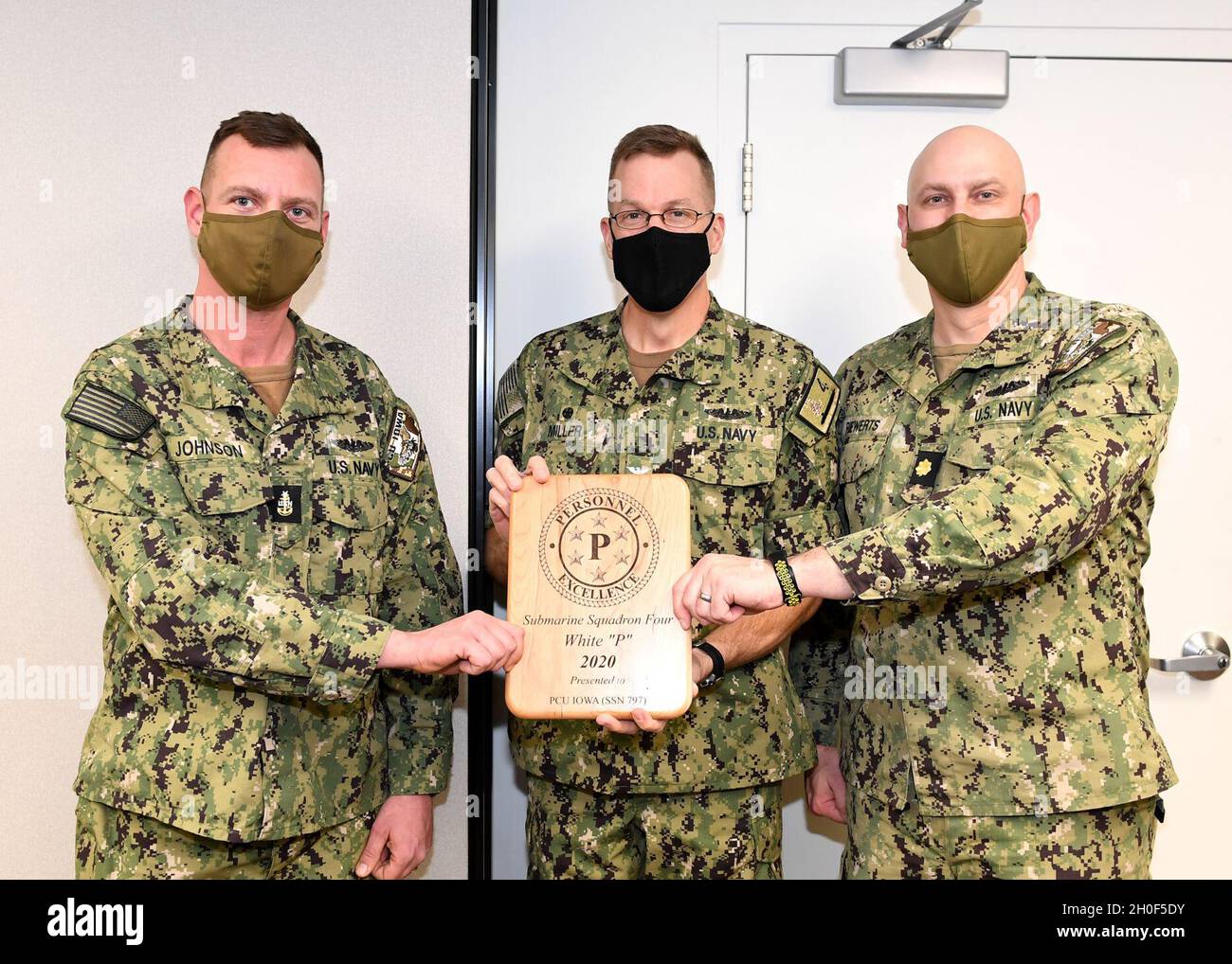 210222-N-GR655-016 GROTON, Connecticut (22. Februar 2021) – Capt. Andrew Miller, commodore für Submarine Squadron (SUBRON) FOUR, Center, überreicht die Personalauszeichnung „P“ an die Besatzung der Vorkommissionsaggregat (PCU) der Virginia-Klasse (SSN 797), vertreten durch den führenden Yeoman YNSCS William Johnson, links, und Executive Officer, LT. Cmdr. Randall Riewerts. Der Personalpreis „P“ – basierend auf einer einjährigen Bewertung – würdigt Einheiten, die die höchste Gesamtbewertung in Bezug auf Kampfbereitschaft und administrative Exzellenz für jedes Geschwader der Submarine Force erreicht haben. Stockfoto