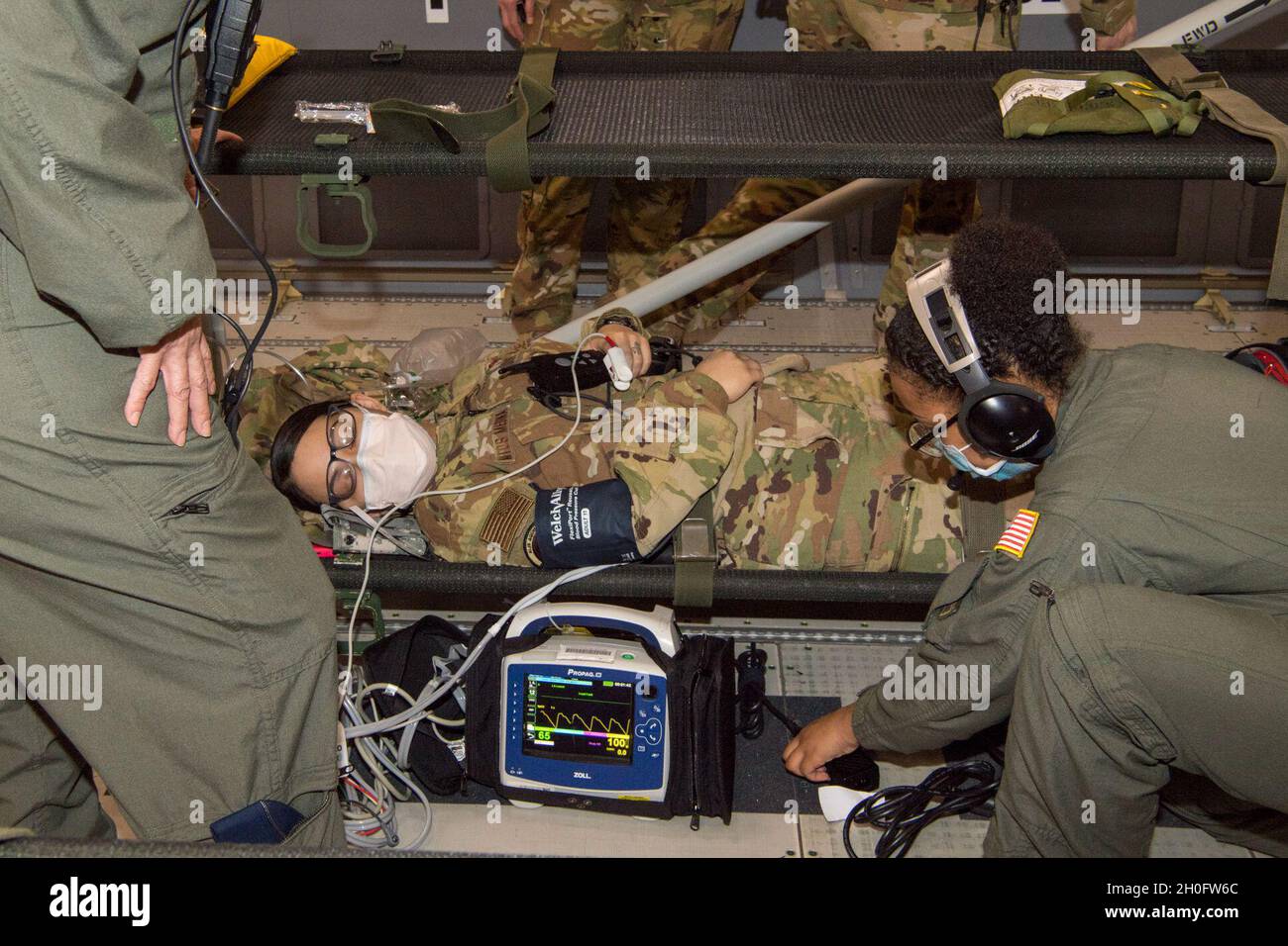 US Air Force Reserve Bürger-Flieger vom 514. Aeromedical Evacuation Squadron überprüfen die Vitalwerte und betreuen einen simulierten Patienten während einer Trainingsmission nach Isla Verde, Puerto Rico, mit dem Air Force Reserve Command, dem Air Mobility Command und dem 916. Lufttankungsflügel am 26. Februar 2021. Mitglieder der 514. UEs wurden an vielen verschiedenen Szenarien evaluiert, die entwickelt wurden, um den medizinischen Kampfdienst in der realen Welt an Bord der KC-46 Pegasus zu replizieren. Die Instruktoren waren vom Air Force Reserve Command und dem Air Mobility Command. Stockfoto