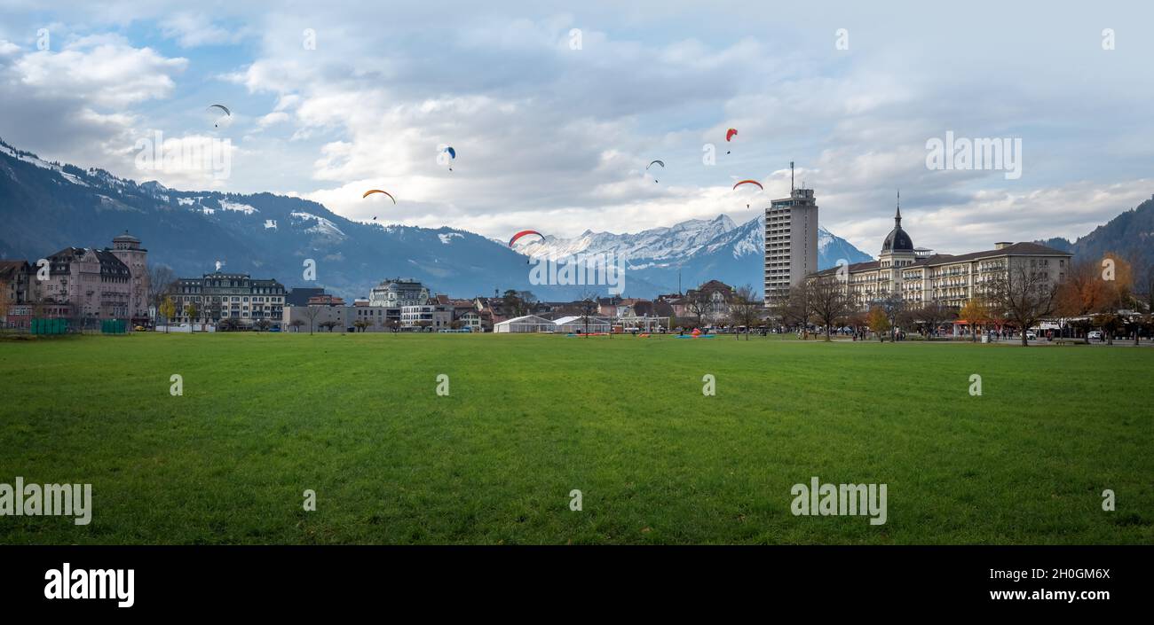 Panoramablick auf den Hohematte Park mit vielen Gleitschirmfliegern - Interlaken, Schweiz Stockfoto