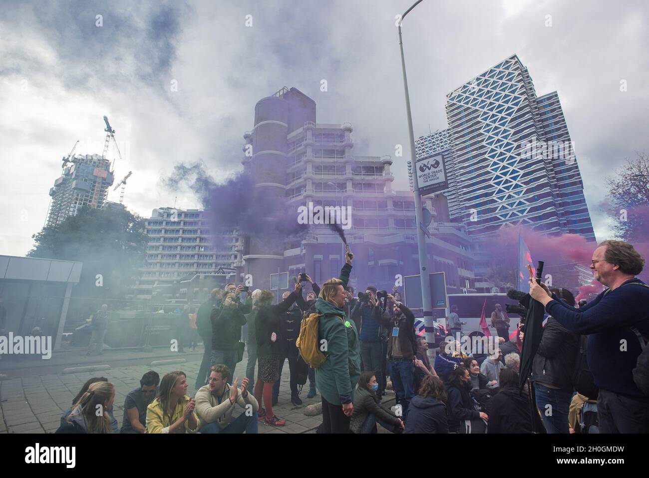 Während der Klimaproteste in Den Haag haben Demonstranten Rauchfackeln ausgelöst.Extinction Rebellion (er) veranstaltete einen großen Klimaprotest in Den Haag, an dem schätzungsweise 200 bis 300 Klimaaktivisten beteiligt waren. ER plant, für die nächsten sieben Tage Demonstrationen zu inszenieren, einige bereits angekündigt und andere nicht; einschließlich der Blockierung der Kreuzung zwischen dem temporären Repräsentantenhaus und dem Ministerium für Wirtschaft und Klima. Die Aktion steht eine Woche vor einer großen UN-Klimakonferenz, dem COP26-Gipfel in Glasgow, Schottland, zwischen dem 31. Oktober und dem 12. November 2021, unter der Präsidentschaft der Vereinigten Staaten Stockfoto