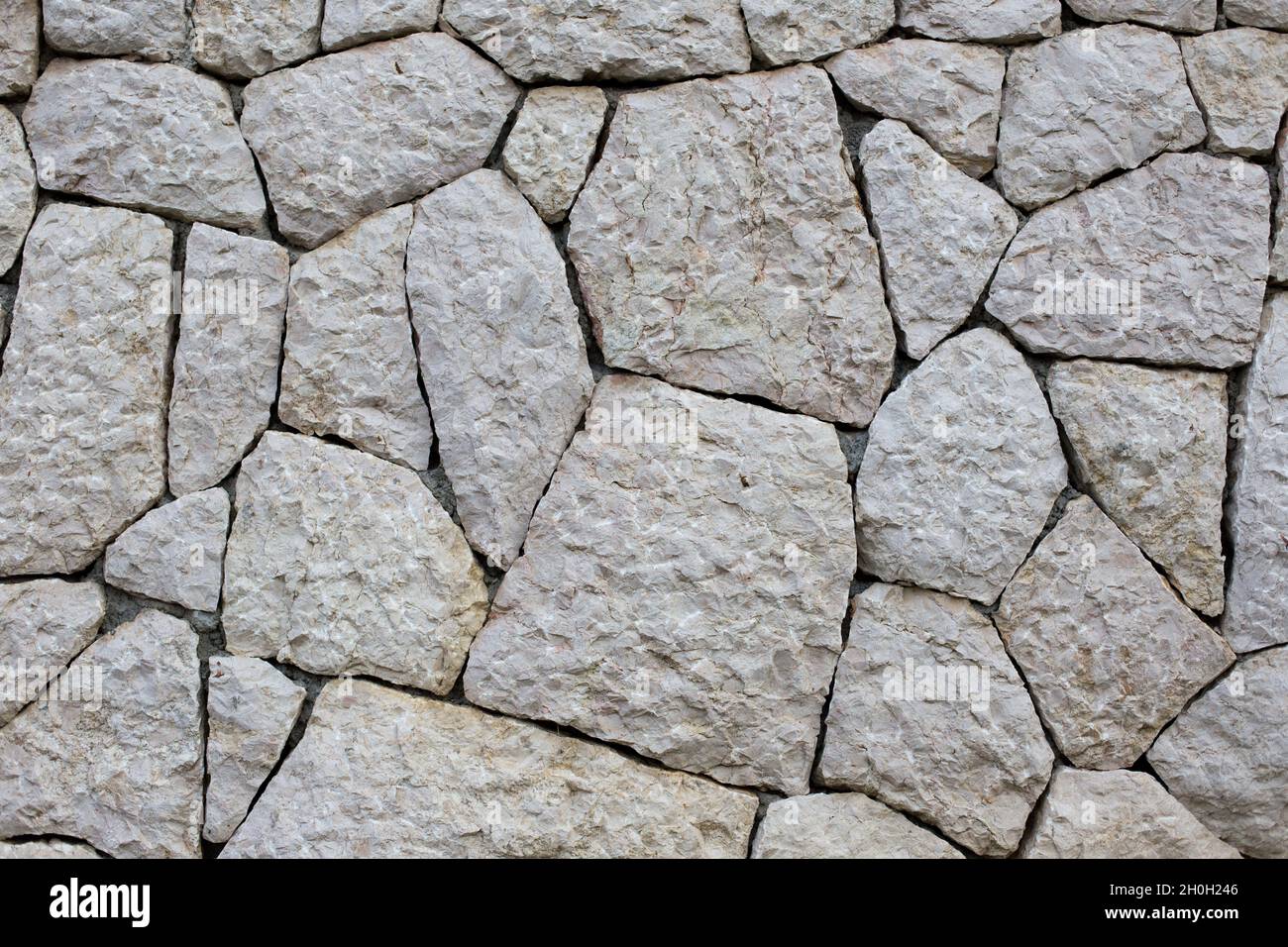 Stein Wandstruktur aus unregelmäßigen Formen aus weißem Material Stockfoto