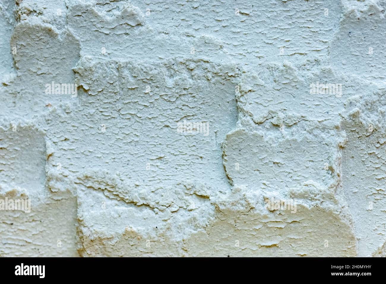 Nahaufnahme der Textur eines weißen Spackle Backsteins Stockfoto