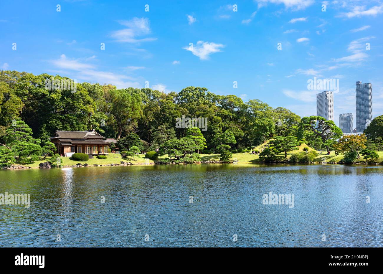 tokio, japan - oktober 14 2021: Traditioneller japanischer Chashitsu-Teeraum Matsu-no-Ochaya entlang des Shiori-no-ike-Teiches der Hama-Rikyū-Gärten mit Skyscr Stockfoto