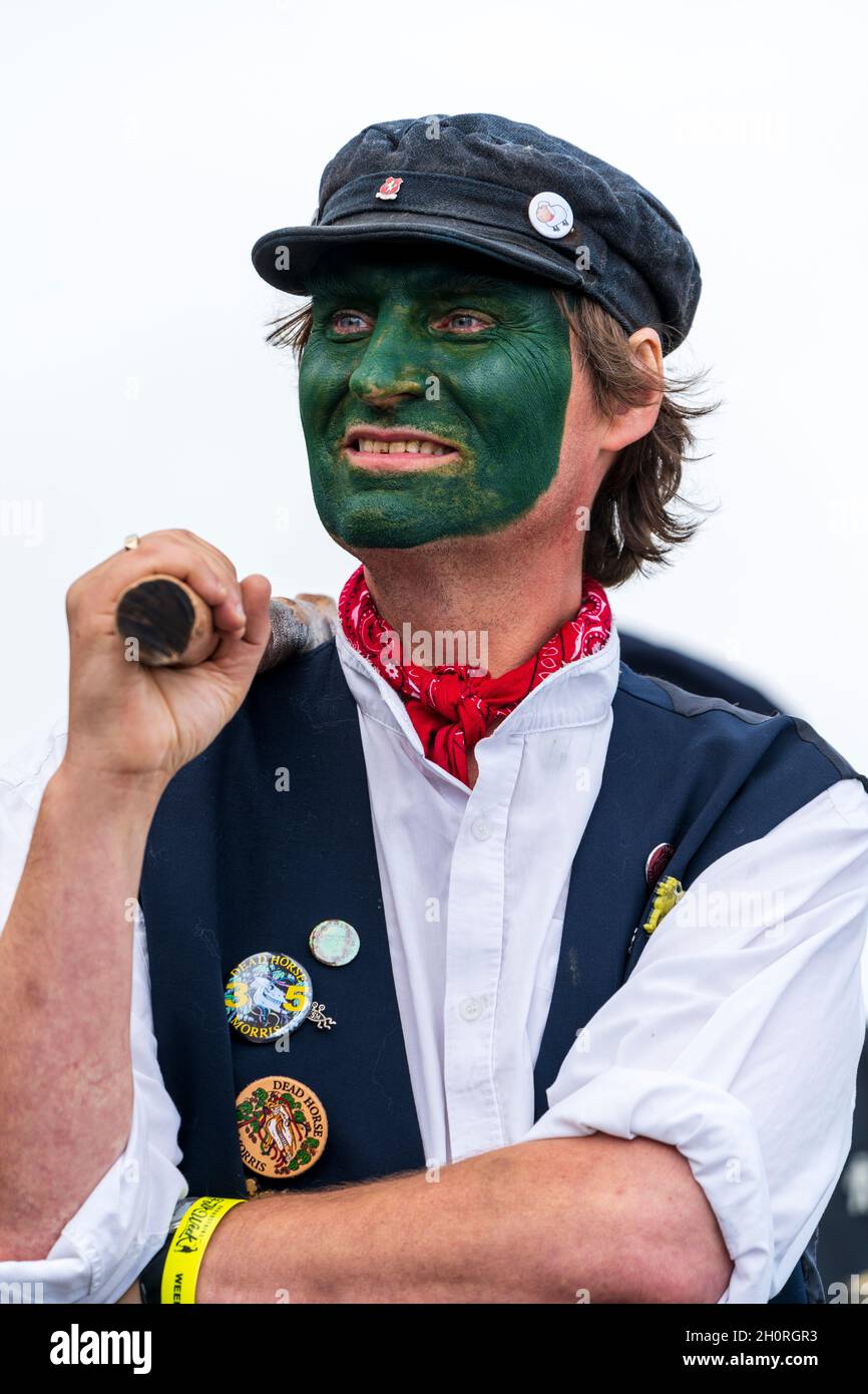 Nahaufnahme eines reifen morris-Tänzers mit grün gemaltem Gesicht und einem Stab über der Schulter. Von der Whitstable Dead Horse Morris Seite. Stockfoto