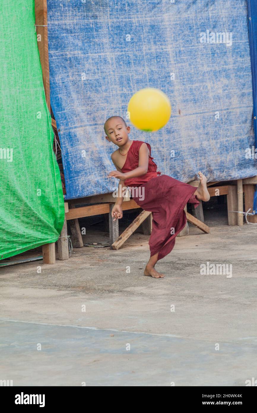 INLE, MYANMAR - 28. NOVEMBER 2016: Buddhistischer Novize spielt mit einem Ball in der Alodaw Pauk Pagode am Inle-See, Myanmar Stockfoto