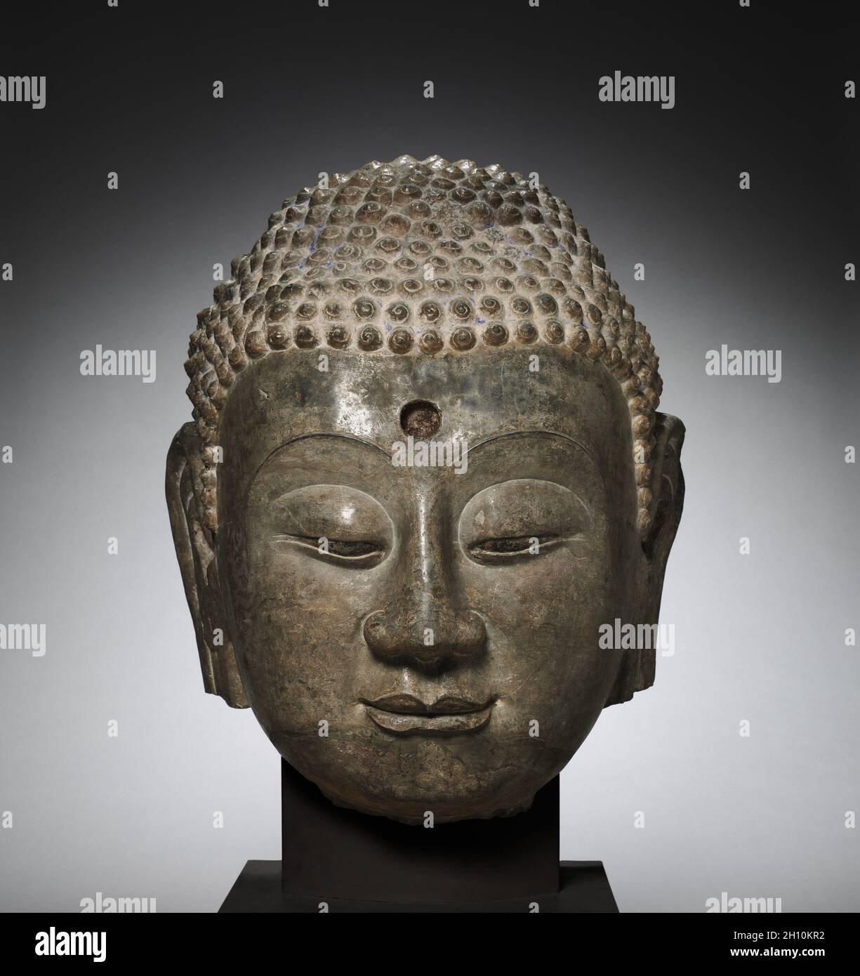 Kopf des Buddha, C. 570. China, Provinz Hebei, nördliche Xiangtangshan Höhlen, South Cave, Nördliche Qi Dynastie (550-577). Kalkstein; gesamt: 62,2 x 54,6 cm (24 1/2 x 21 1/2 in.). Stockfoto