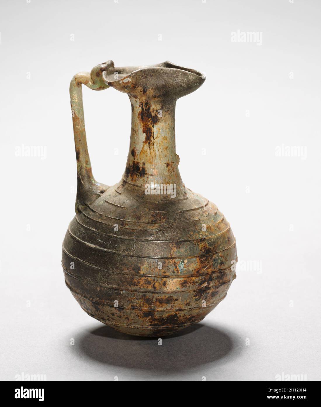 Krug mit Griff, AD 100-400. Römisch, östliches Mittelmeer, 2. Jahrhundert oder später. Glas; insgesamt: 11.5 x 7.5 cm (4 1/2 x 2 15/16 Zoll). Stockfoto