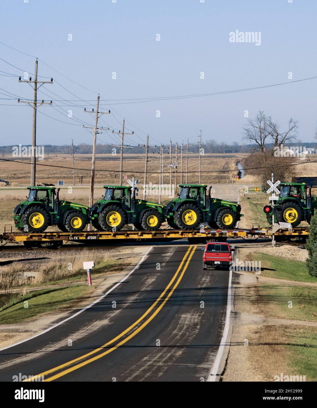 Eisenbahn-Flachwagen mit John Deere-Traktoren werden ins Ausland exportiert Stockfoto