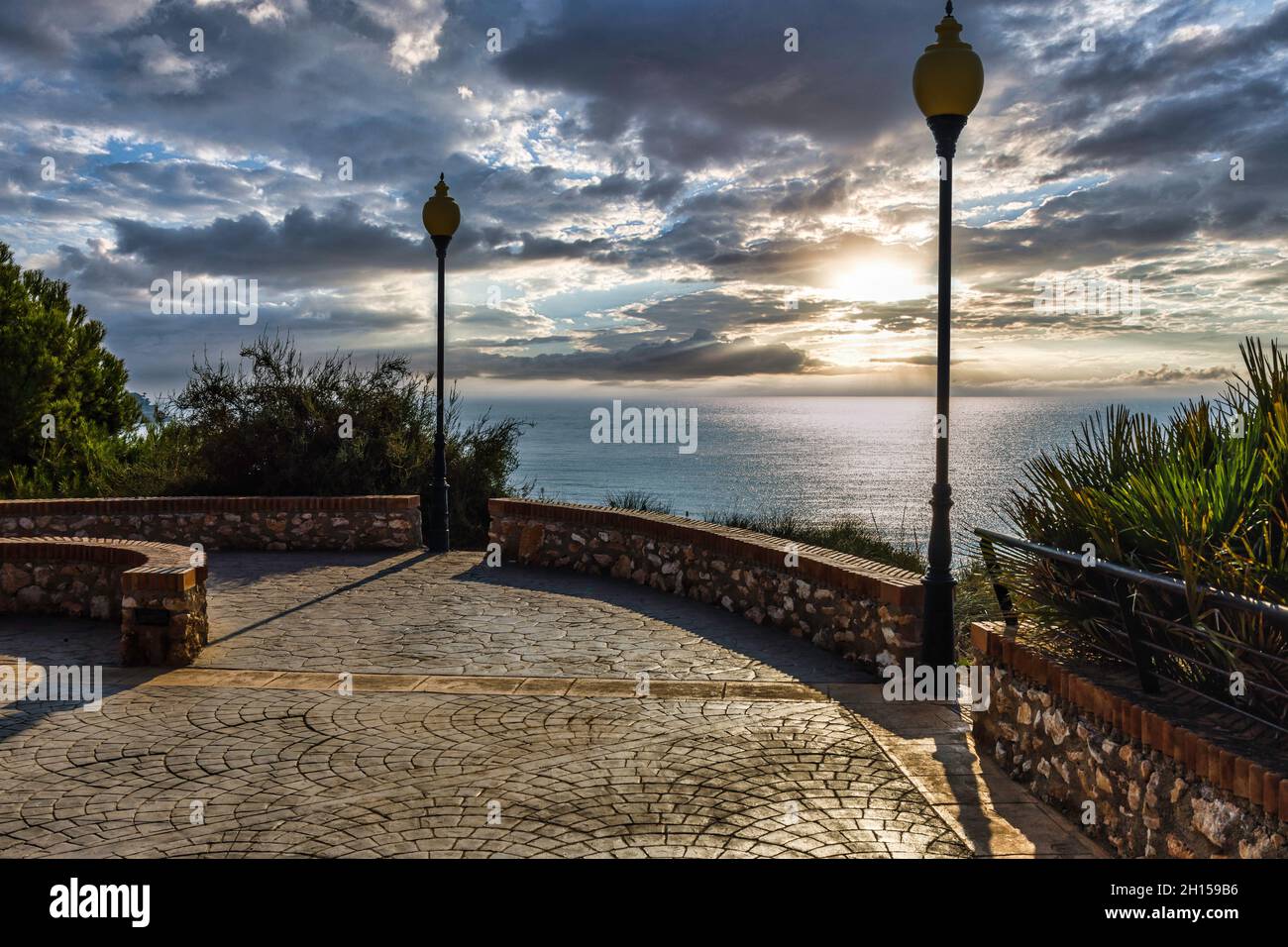 Wanderterrasse und Blick auf das Meer mit wunderschönen Wolken bei Sonnenuntergang Stockfoto