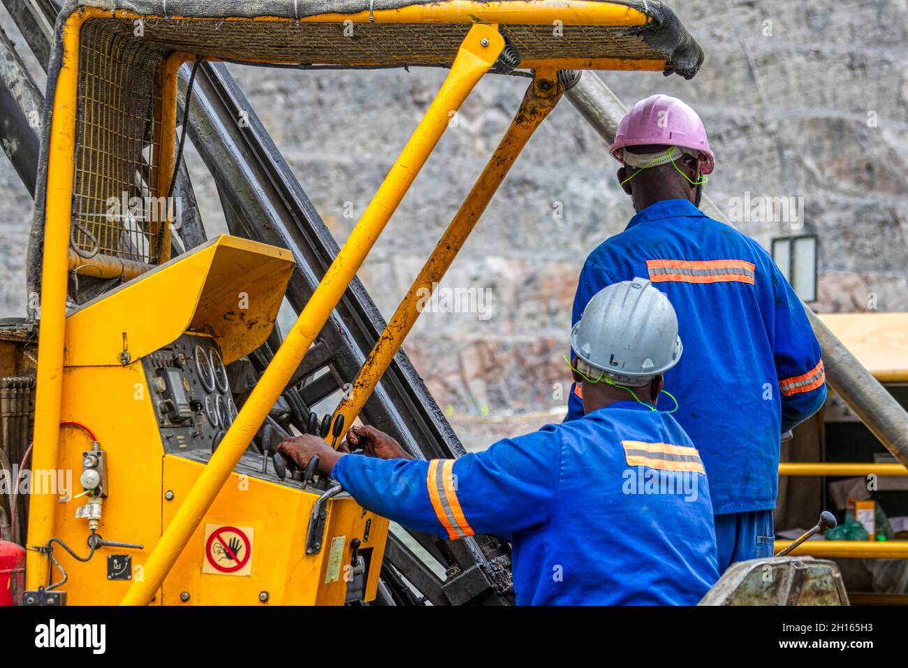 Afrikanische Arbeiter, die eine schwere Maschine betreiben, sind die Diamantenmine in Jwaneng, Botswana Stockfoto