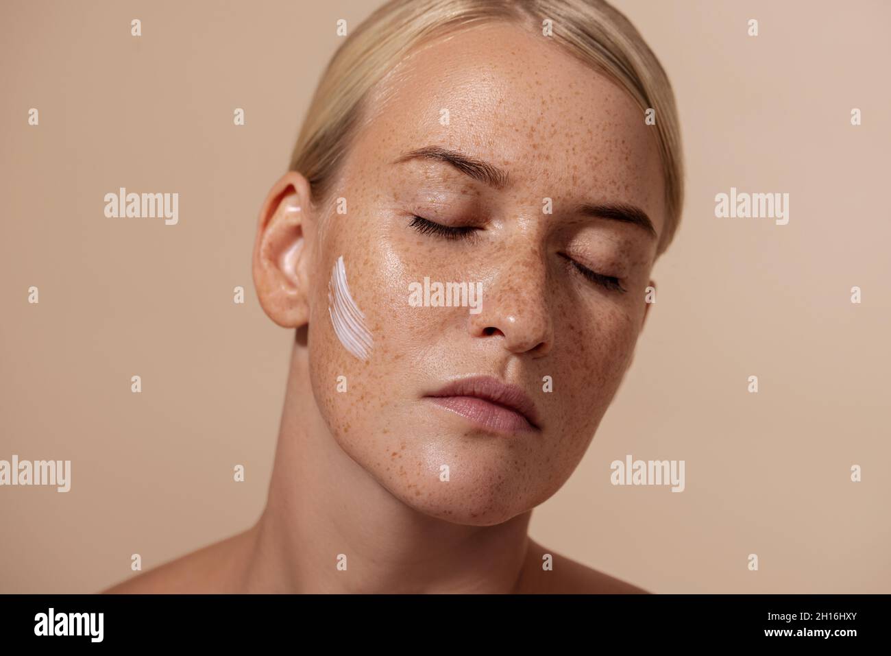 Nahaufnahme Porträt der schönen kaukasischen Frau mit Anti-Aging-Creme auf dem Gesicht Stockfoto