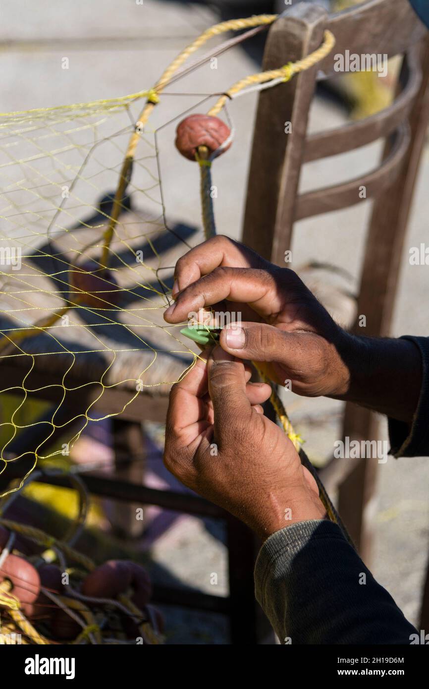 Ein Fischer repariert ein Netz. Ermoupoli, Siros-Insel, Kykladen-Inseln, Griechenland. Stockfoto
