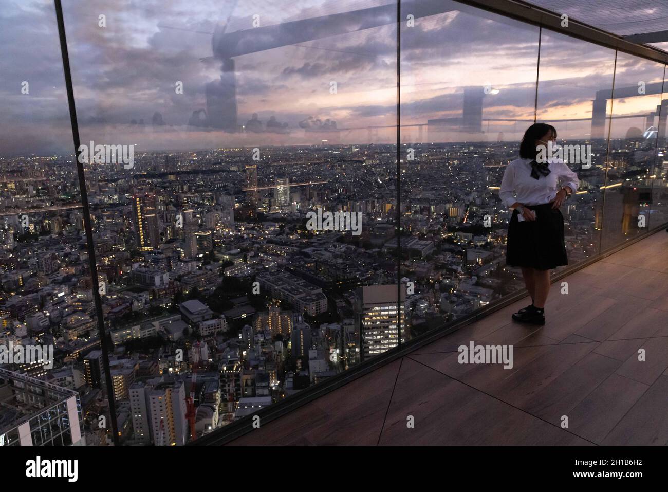 Besucher des Shibuya Sky fotografiert während des Sonnenuntergangs auf der oberen Etage der Aussichtsplattform.Shibuya Sky ist eine neue Attraktion für inländische und internationale Touristen mit einem großartigen Blick über Tokio. Stockfoto