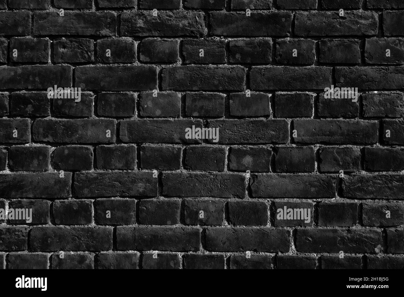 Alte schwarze Ziegelwand, Backsteinwand Hintergrundstruktur. Stockfoto