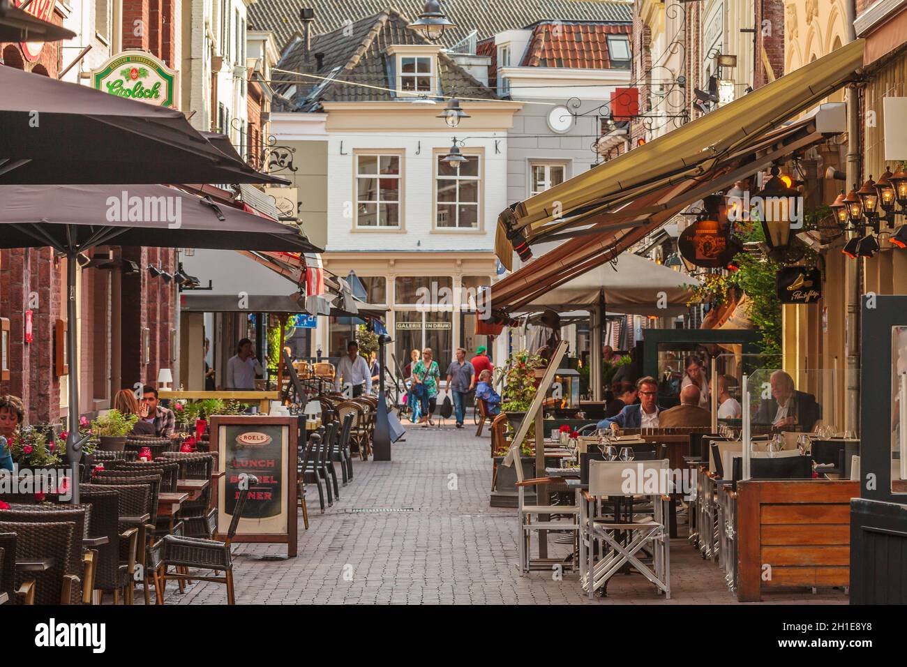DEN Bosch - AUGUST 12: Restaurantterrassen in einer kleinen Gasse im historischen Stadtzentrum der niederländischen Stadt Den Bosch. Stockfoto