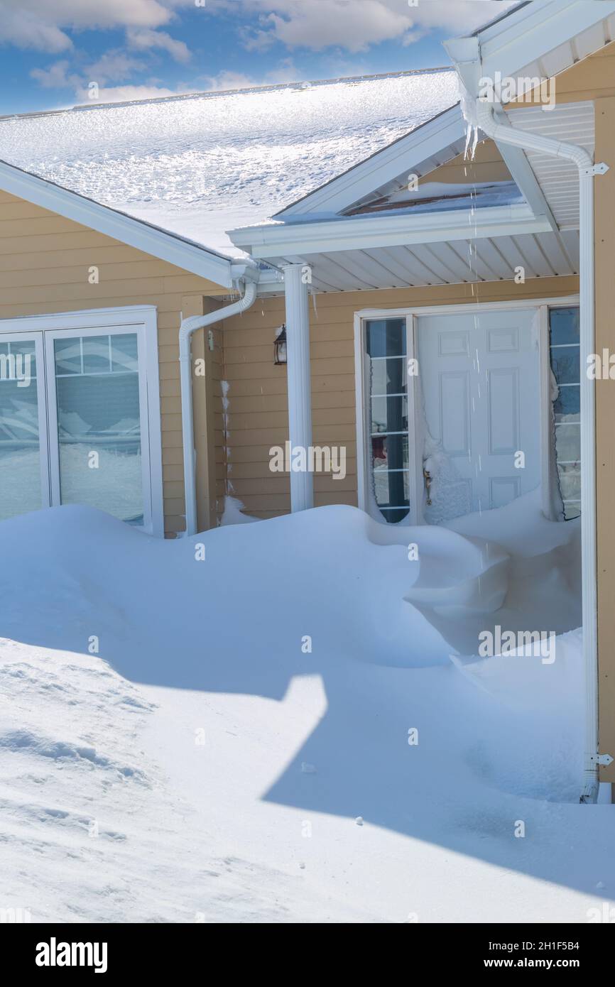 Nach einem Schneesturm türmte sich Schnee in eine Tür. Stockfoto