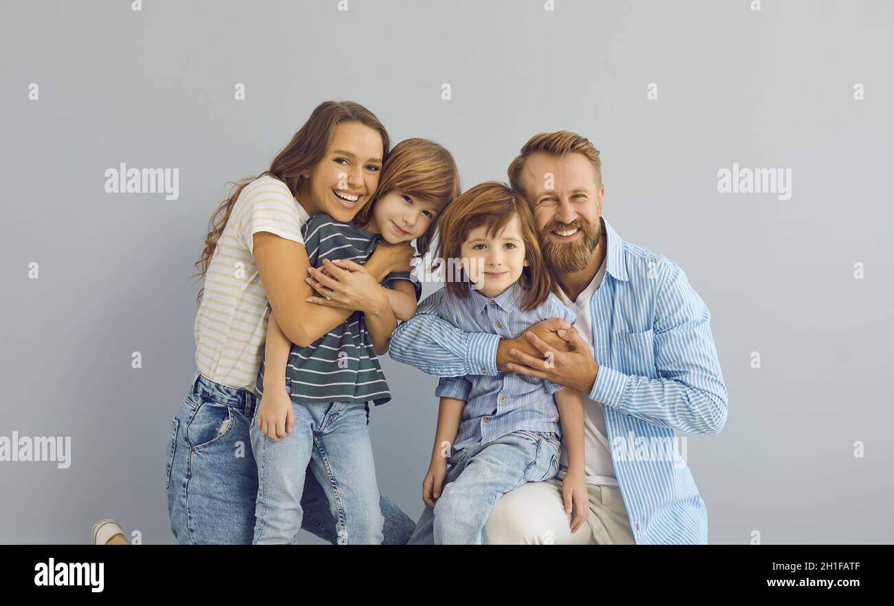 Studioportrait von glücklicher Mutter, Vater und Kindern, die lächeln und die Kamera betrachten Stockfoto