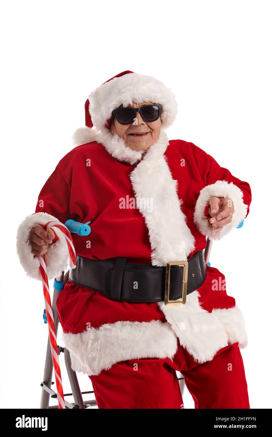 Ein Nonagenist in einem Weihnachtsmann-Kostüm, der auf einem Spaziergänger mit weißem Hintergrund sitzt. Stockfoto