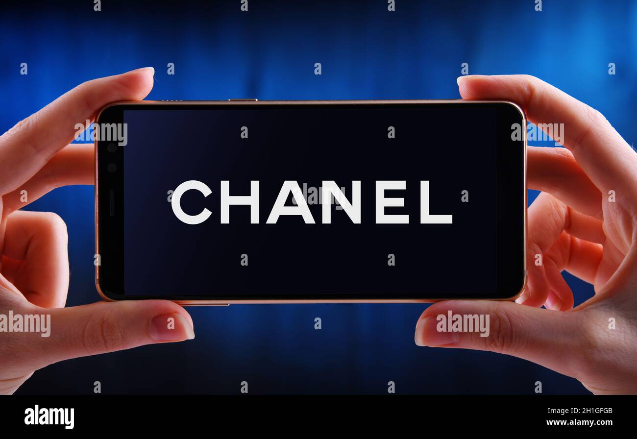 POZNAN, POL - JUN 12, 2020: Hand halten Smartphone mit Logo von Chanel, ein Luxus-Unternehmen, das sich auf High-Fashion und Ready-made Kleidung, l Stockfoto