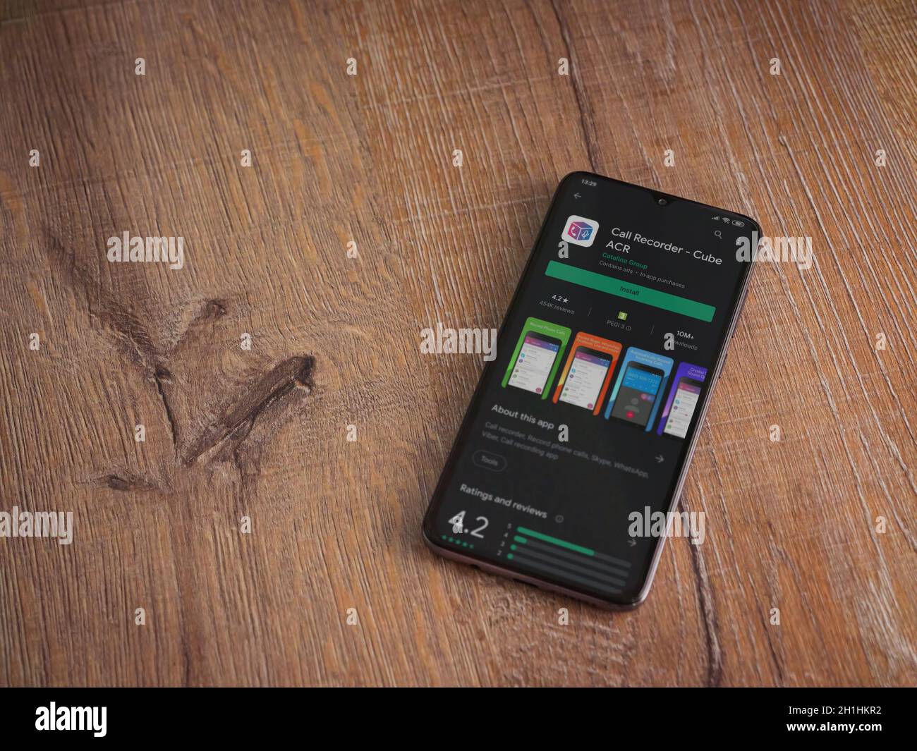 LOD, Israel - 8. Juli 2020: Cube ACR App Play Store Seite auf dem Display eines schwarzen Smartphone auf Holzhintergrund. Draufsicht flach liegend mit Kopie Stockfoto