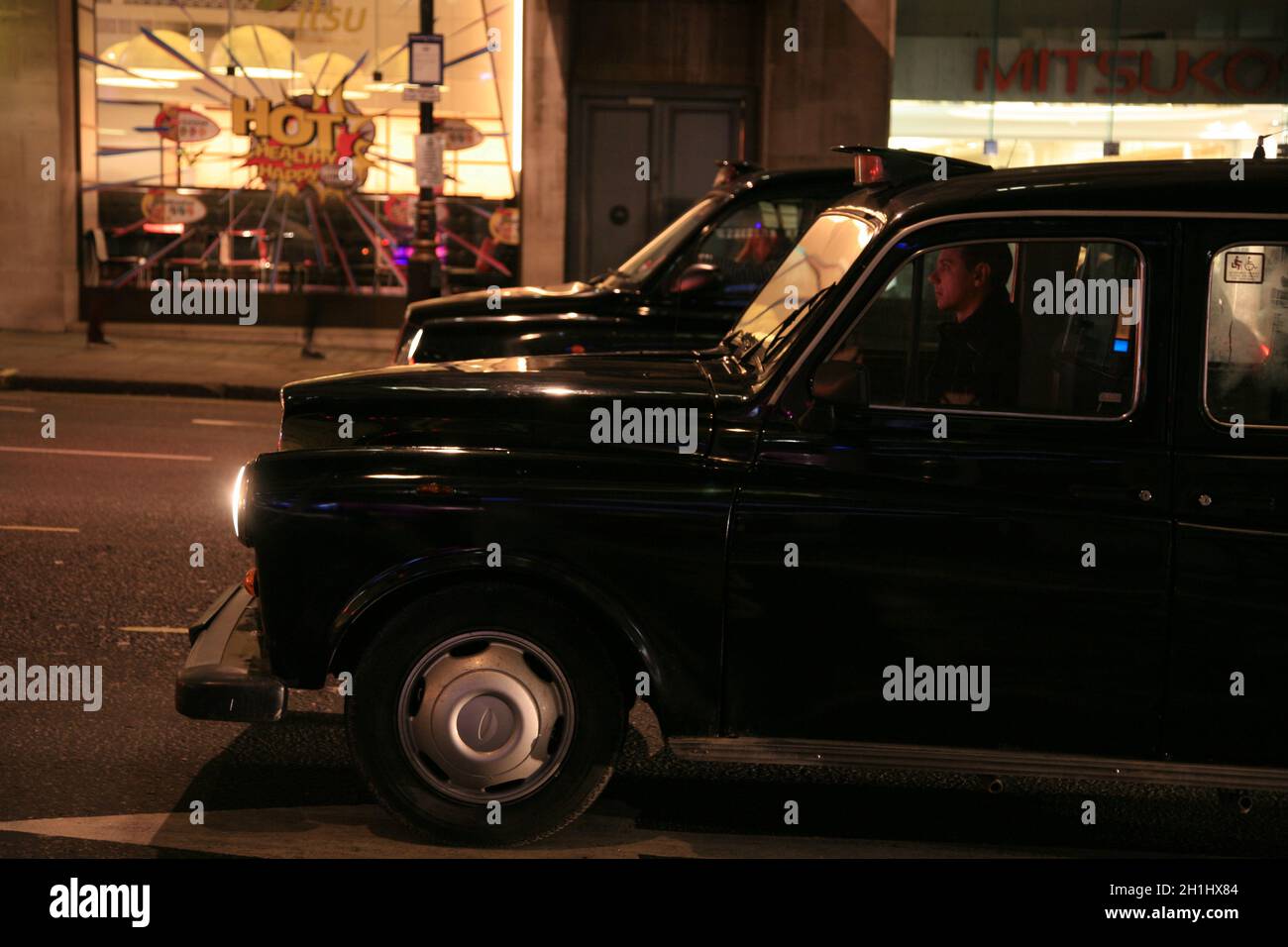 London, Großbritannien - 21. Januar 2011: Taxi in der Straße von London. Taxis sind das ikonischste Symbol Londons sowie Londons Red Double Decker Bus. Stockfoto