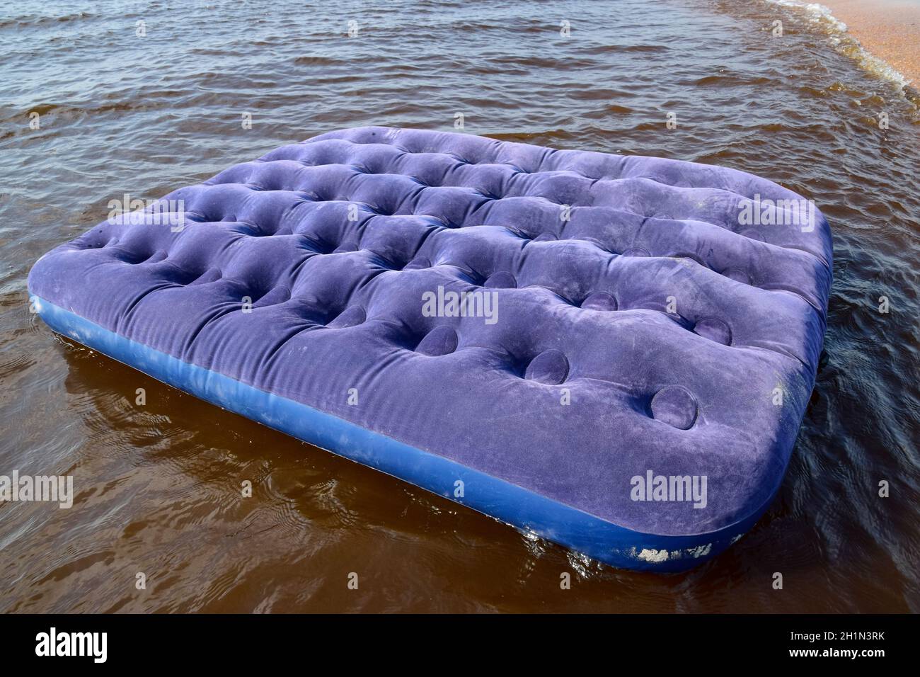 Blaue Luftmatratze im Teich schwimmen. Eine aufblasbare Matratze am Strand  Stockfotografie - Alamy